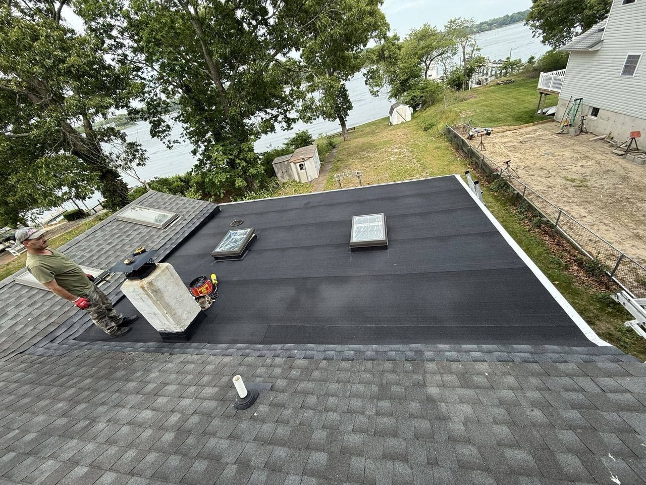 Waterfront home: new decking and flat roof section - after